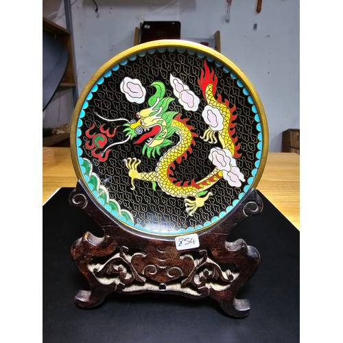 178 - An interesting cloissone plate with an oriental dragon design presenting vibrant colours and complet... 