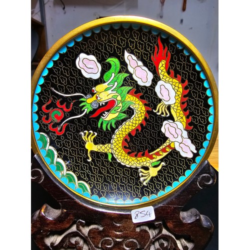 178 - An interesting cloissone plate with an oriental dragon design presenting vibrant colours and complet... 