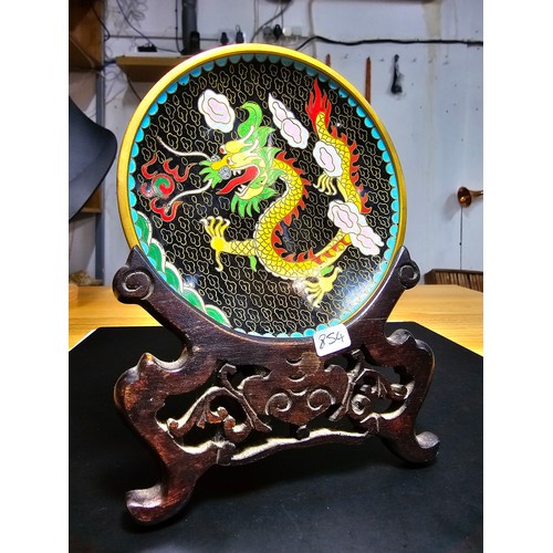 178 - An interesting cloissone plate with an oriental dragon design presenting vibrant colours and complet... 