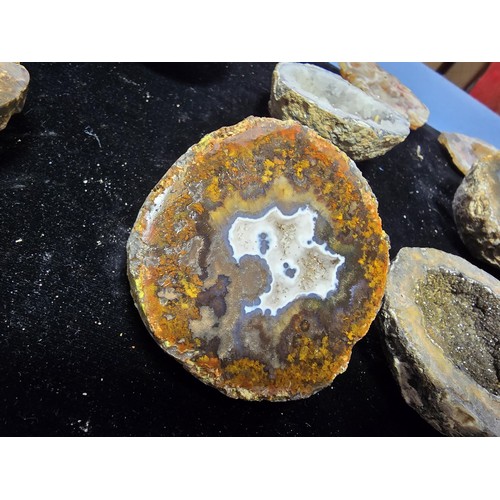 115 - A large collection of small, round geode slices presenting some stunning natural patterns inside and... 