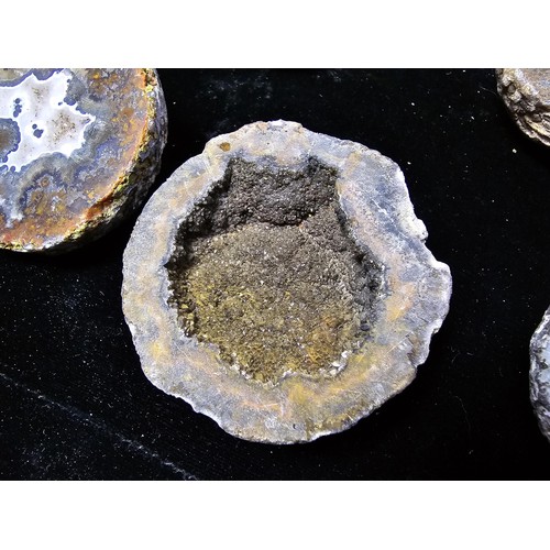 115 - A large collection of small, round geode slices presenting some stunning natural patterns inside and... 