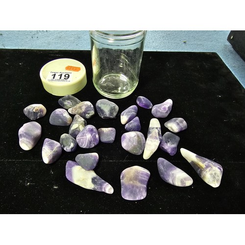 119 - A selection of polished and tumbled amethyst specimens in a glass jar presenting some beautiful indi... 