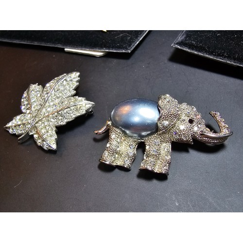 233 - A suite of costume brooches on 2 boards which includes some ornate jewelled animal formed brooches f... 