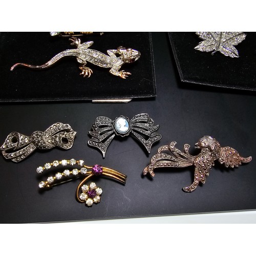 233 - A suite of costume brooches on 2 boards which includes some ornate jewelled animal formed brooches f... 