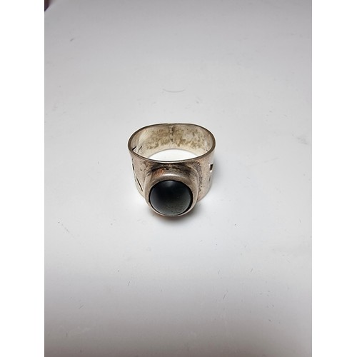 192 - Chunky solid silver dress ring inset with a blue tigers eye stone showing good green and blue flashe... 