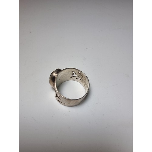 192 - Chunky solid silver dress ring inset with a blue tigers eye stone showing good green and blue flashe... 