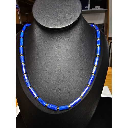 189 - A fine quality lapis lazuli and 9ct gold beaded necklace featuring faceted barrel formed lapis lazul... 