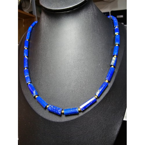 189 - A fine quality lapis lazuli and 9ct gold beaded necklace featuring faceted barrel formed lapis lazul... 