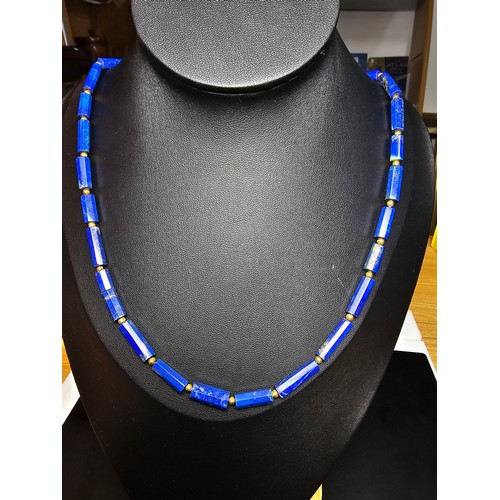 189 - A fine quality lapis lazuli and 9ct gold beaded necklace featuring faceted barrel formed lapis lazul... 