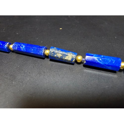 189 - A fine quality lapis lazuli and 9ct gold beaded necklace featuring faceted barrel formed lapis lazul... 