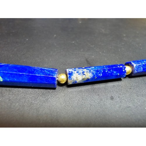 189 - A fine quality lapis lazuli and 9ct gold beaded necklace featuring faceted barrel formed lapis lazul... 
