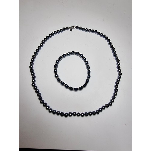 222 - Fine quality crown Jersey black pearl necklace and matching bracelet which are beautifully cultured.... 