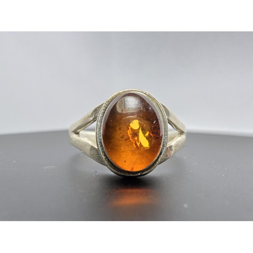 219 - Pretty 925 silver ring inset with a natural Baltic amber Cabochon stone in good clean condition and ... 