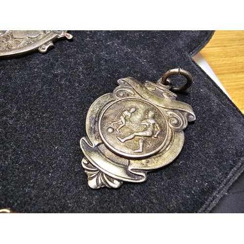 213 - A collection of 8x various medals to include 4 Sterling Silver medals, 3 of which are football relat... 