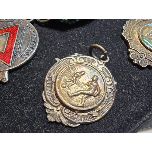 213 - A collection of 8x various medals to include 4 Sterling Silver medals, 3 of which are football relat... 