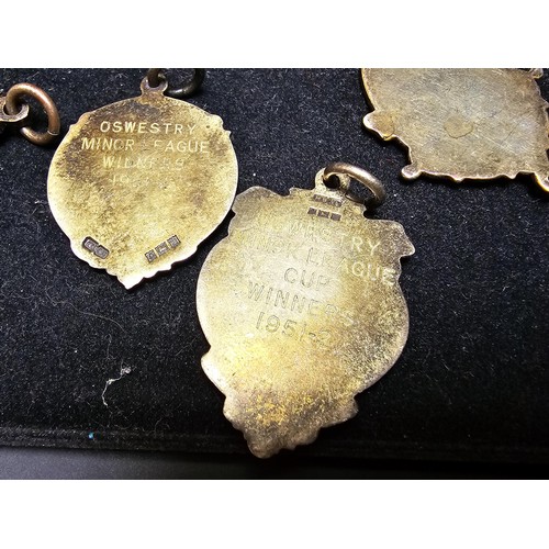 213 - A collection of 8x various medals to include 4 Sterling Silver medals, 3 of which are football relat... 