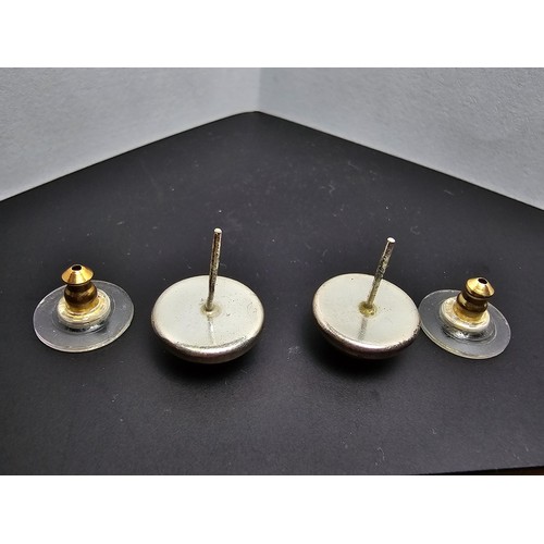 212 - A pair of pretty 925 silver large stud earrings inset with natural Baltic amber stones presenting a ... 