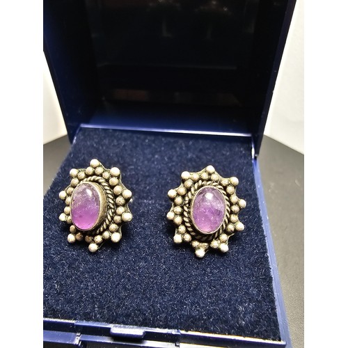 211 - A pair of 925 silver ornate vintage earrings inset with natural amethyst cabochon stones, in good cl... 