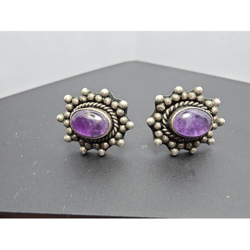 211 - A pair of 925 silver ornate vintage earrings inset with natural amethyst cabochon stones, in good cl... 