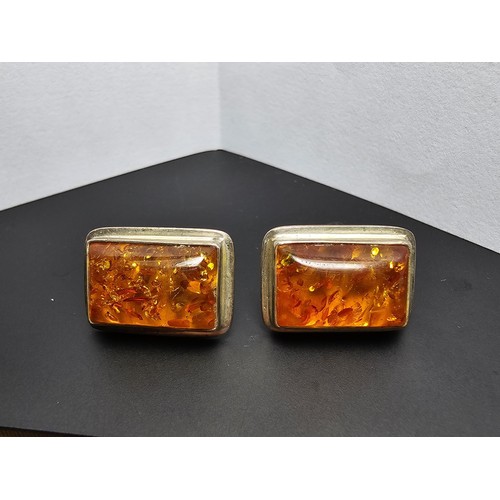 209 - A pair of 925 silver vintage amber earrings inset with large rectangular natural Baltic amber stones... 