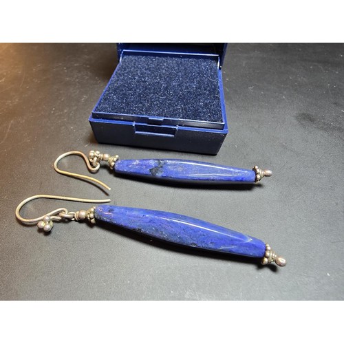 208 - A pair of tested as sterling silver long drop earrings featuring faceted sodalite stones, in good cl... 