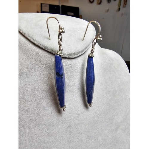 208 - A pair of tested as sterling silver long drop earrings featuring faceted sodalite stones, in good cl... 