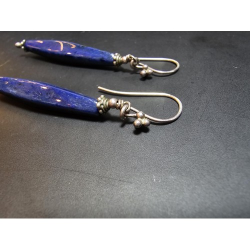 208 - A pair of tested as sterling silver long drop earrings featuring faceted sodalite stones, in good cl... 