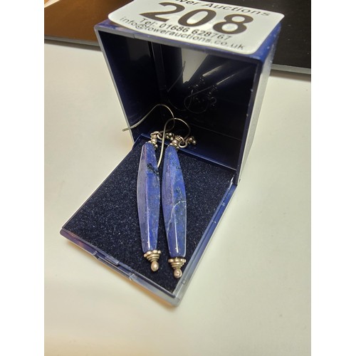 208 - A pair of tested as sterling silver long drop earrings featuring faceted sodalite stones, in good cl... 