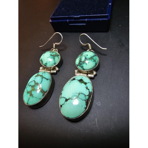204 - A good quality vintage 925 silver pair of drop earrings inset with 2 large natural turquoise stones ... 
