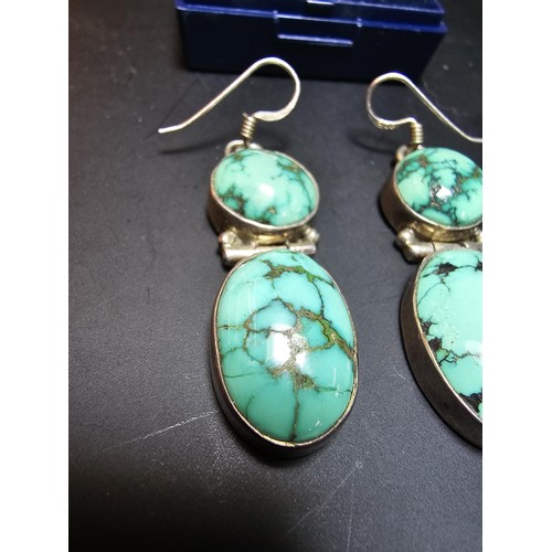 204 - A good quality vintage 925 silver pair of drop earrings inset with 2 large natural turquoise stones ... 