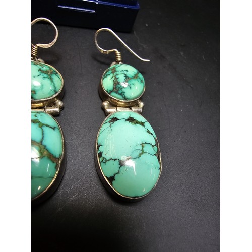 204 - A good quality vintage 925 silver pair of drop earrings inset with 2 large natural turquoise stones ... 