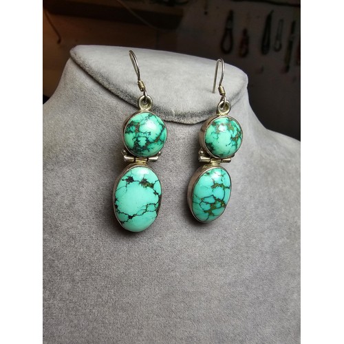 204 - A good quality vintage 925 silver pair of drop earrings inset with 2 large natural turquoise stones ... 
