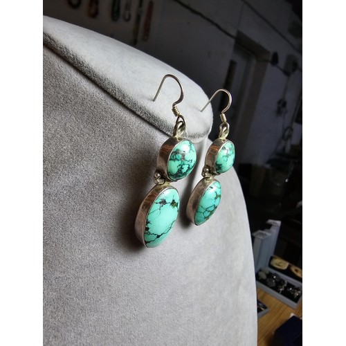 204 - A good quality vintage 925 silver pair of drop earrings inset with 2 large natural turquoise stones ... 