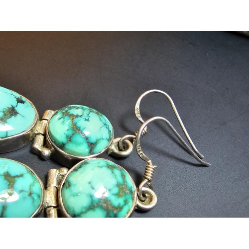 204 - A good quality vintage 925 silver pair of drop earrings inset with 2 large natural turquoise stones ... 