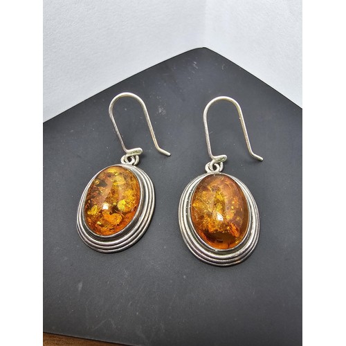 203 - A large good quality 925 silver pair of amber earrings inset wit large natural Baltic amber cabochon... 