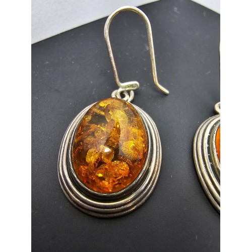 203 - A large good quality 925 silver pair of amber earrings inset wit large natural Baltic amber cabochon... 