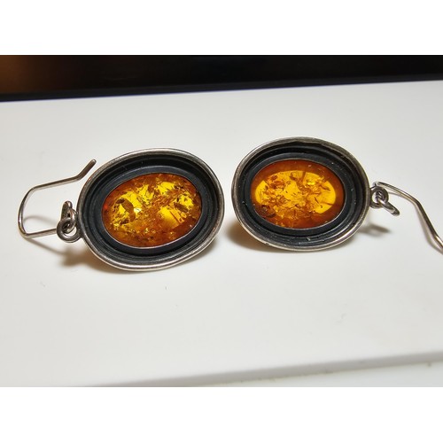 203 - A large good quality 925 silver pair of amber earrings inset wit large natural Baltic amber cabochon... 
