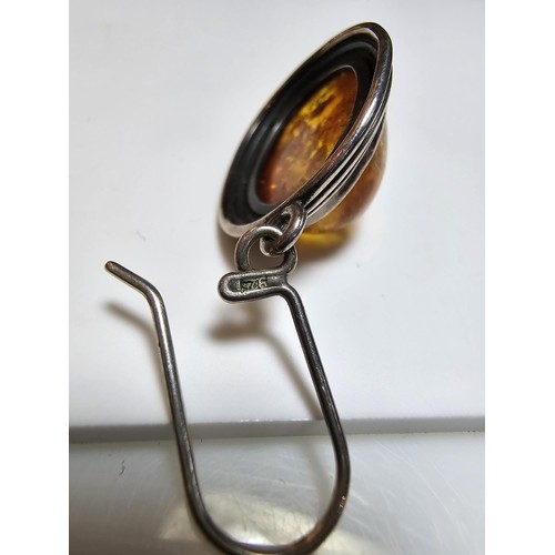 203 - A large good quality 925 silver pair of amber earrings inset wit large natural Baltic amber cabochon... 
