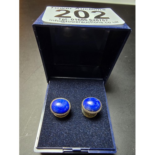 202 - A pair of 925 sterling silver stud earrings inset with large natural lapis lazuli stones, presenting... 