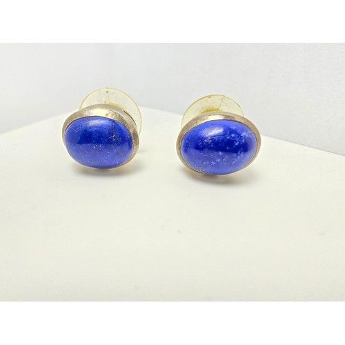 202 - A pair of 925 sterling silver stud earrings inset with large natural lapis lazuli stones, presenting... 