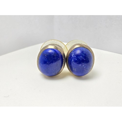 202 - A pair of 925 sterling silver stud earrings inset with large natural lapis lazuli stones, presenting... 