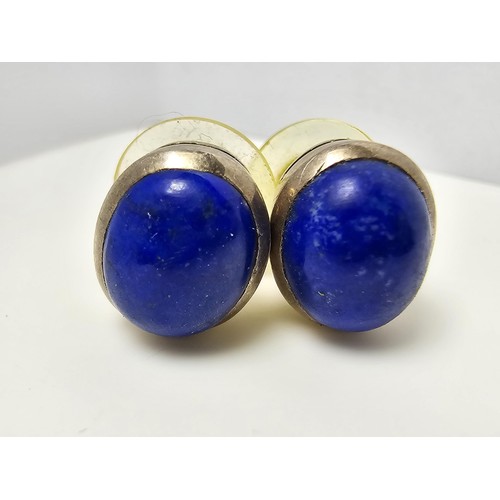 202 - A pair of 925 sterling silver stud earrings inset with large natural lapis lazuli stones, presenting... 