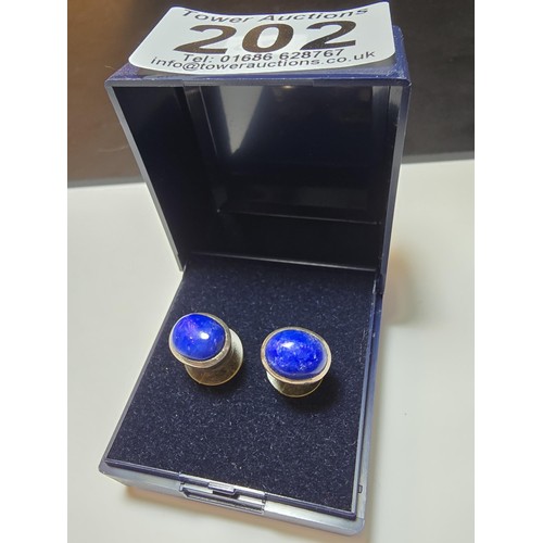 202 - A pair of 925 sterling silver stud earrings inset with large natural lapis lazuli stones, presenting... 