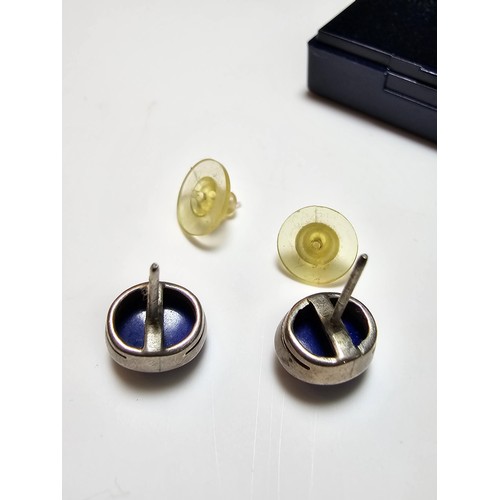 202 - A pair of 925 sterling silver stud earrings inset with large natural lapis lazuli stones, presenting... 