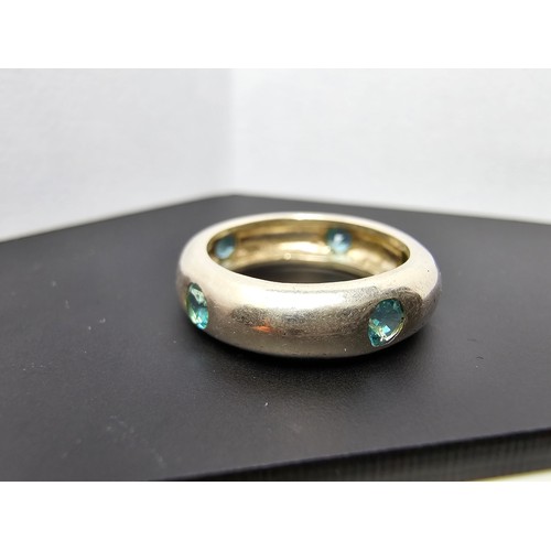 220 - A chunky 925 silver ring inset with faceted blue crystal CZ stones all the way around. In good clean... 
