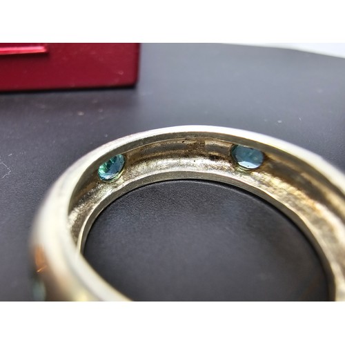 220 - A chunky 925 silver ring inset with faceted blue crystal CZ stones all the way around. In good clean... 