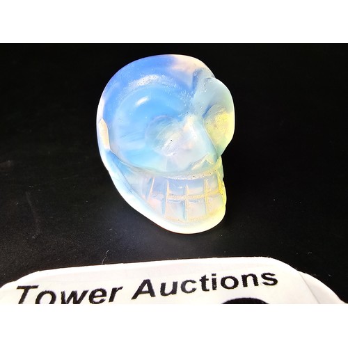 275 - 2x well carved opalite skull ornaments to include a blue opalite bird skull piece and a clear opalit... 