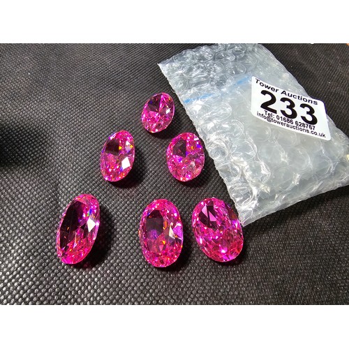 233 - A large collection of 6x large pink faceted crystal glass stones which are imitation sapphires. The ... 