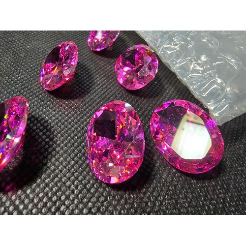 233 - A large collection of 6x large pink faceted crystal glass stones which are imitation sapphires. The ... 