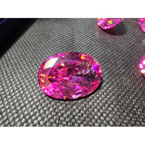 233 - A large collection of 6x large pink faceted crystal glass stones which are imitation sapphires. The ... 